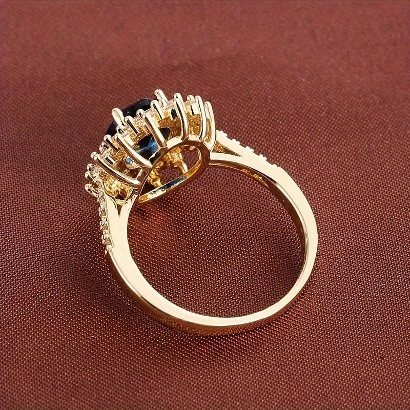 Delphine – Schicker goldener Ring mit blauem Stein